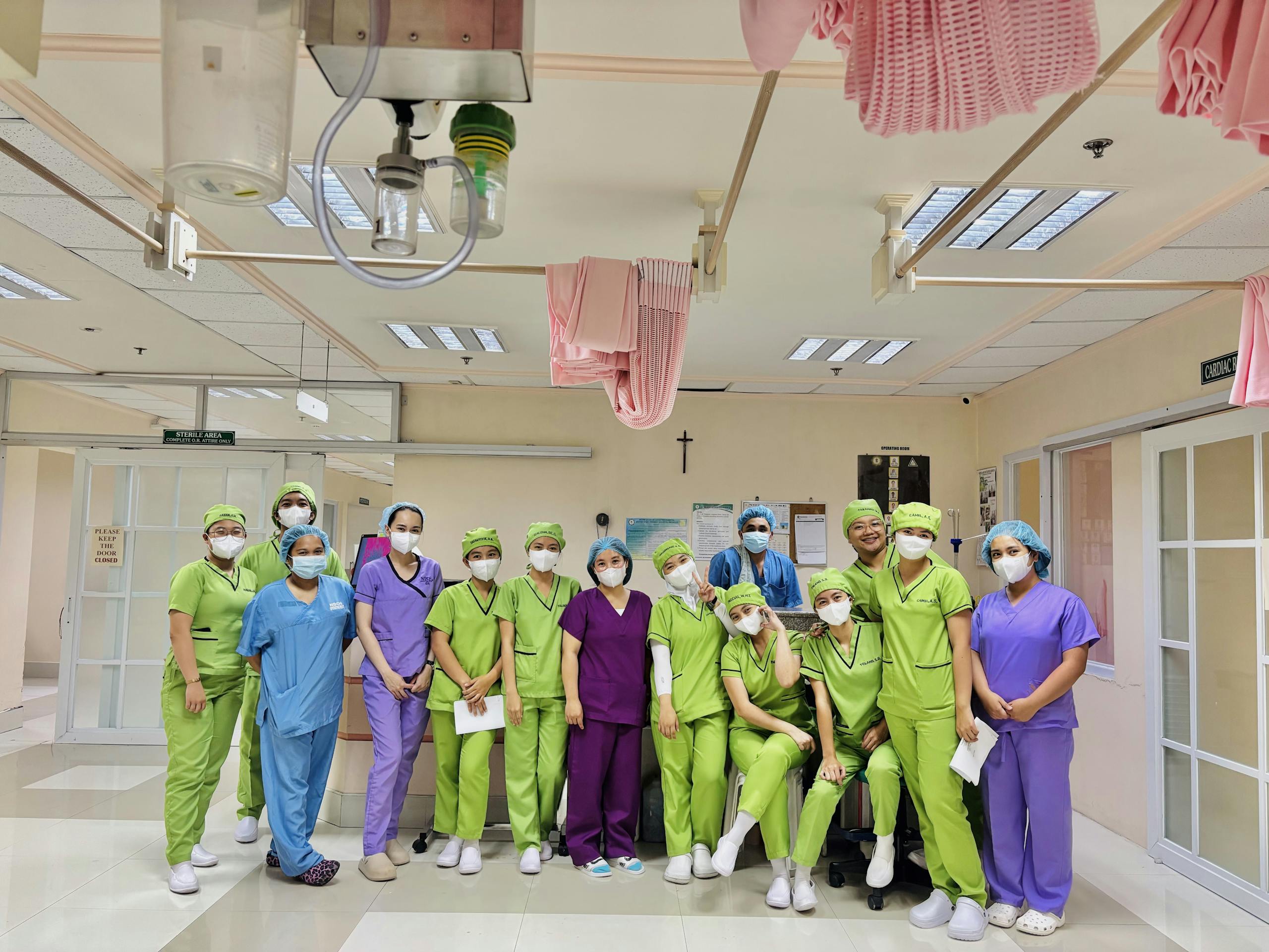 Group of diverse nurses in vivid scrubs inside a hospital ward, Baguio City.